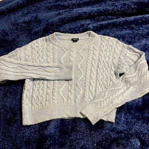 Cropped light blue sweater.